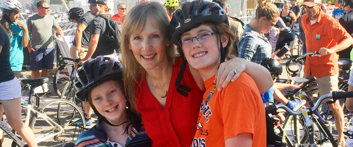 Alum Anne Bailey and boys on bike ride