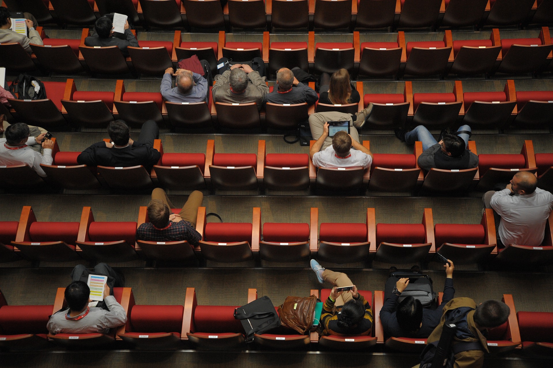The audience listens to a speaker at a conference