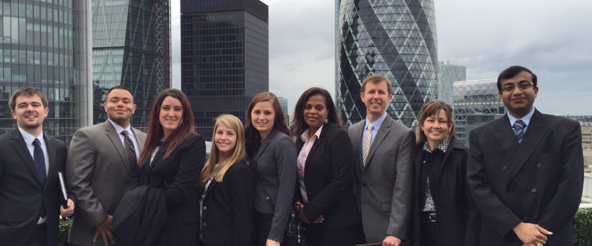 Risk management and insurance students standing in front of London skyline